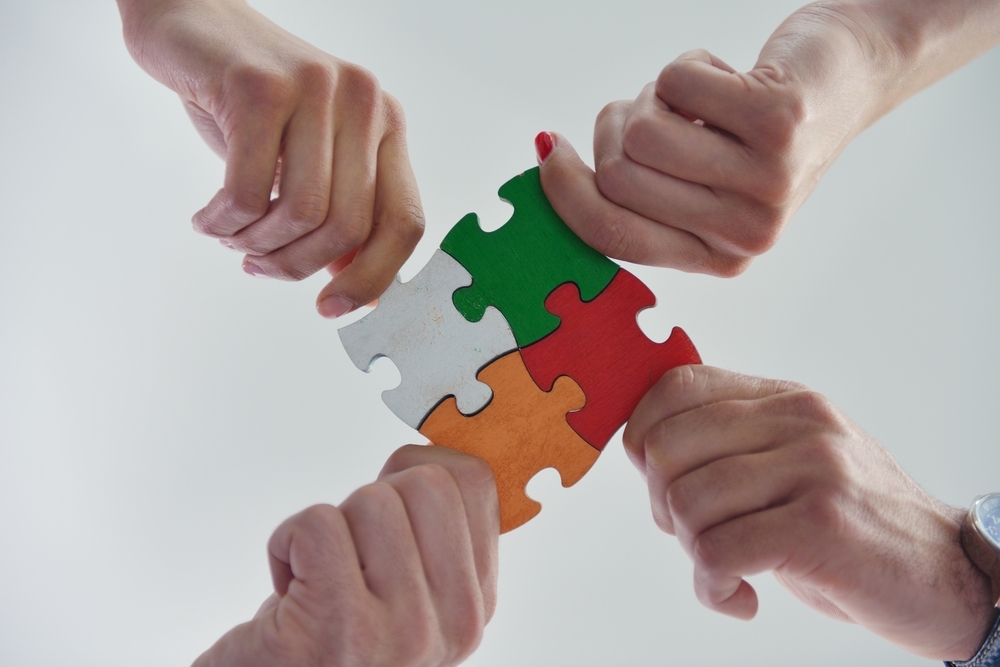 Group of business people assembling jigsaw puzzle and represent team support and help concept Group of business people assembling jigsaw puzzle and represent team support and help concept